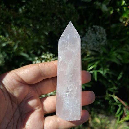 Dumi's Crystals | Rose Quartz Tower (7-10cm) | A close-up view of a captivating Rose Quartz Tower (7-10cm), showcasing its delicate pink hue and intricate patterns. This crystal is believed to promote love, compassion, and emotional healing.