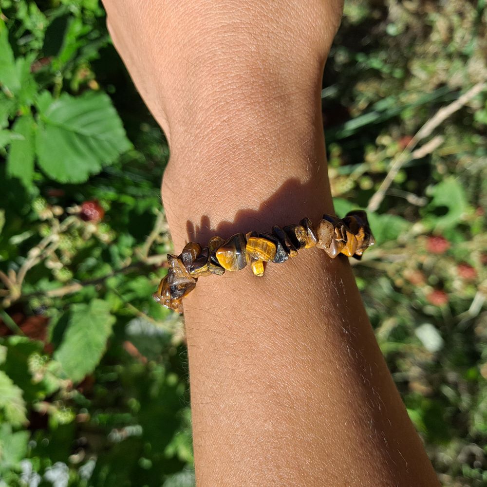 Tiger's Eye Chip Bracelet for strength and focus on wrist | Dumi's Crystals | Embrace inner peace and grounded energy with this Tiger's Eye chip bracelet. Unique chip variations, promotes courage, protection, and clear thinking.
